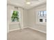 Sunlit bedroom featuring two windows, herringbone accent wall, and neutral carpeting at 258 14Th Ne Ave, St Petersburg, FL 33701