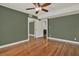Bedroom featuring hardwood floors, ceiling fan, closet with mirrored doors, and neutral wall color at 258 14Th Ne Ave, St Petersburg, FL 33701