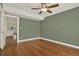 Bedroom with hardwood floors, neutral walls, ceiling fan, and doorway leading to other rooms at 258 14Th Ne Ave, St Petersburg, FL 33701