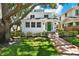 Charming two-story home featuring a green door, and manicured landscaping at 258 14Th Ne Ave, St Petersburg, FL 33701