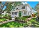 Charming two-story home featuring a green door, manicured landscaping, and brick pathway at 258 14Th Ne Ave, St Petersburg, FL 33701