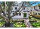 Charming home showcasing a lush front yard, brick walkway, and a welcoming green front door at 258 14Th Ne Ave, St Petersburg, FL 33701