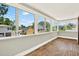 Bright sunroom features hardwood floors and large windows overlooking the surrounding neighborhood at 258 14Th Ne Ave, St Petersburg, FL 33701