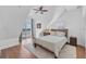 Cozy bedroom offering ample natural light, hardwood floors and a private balcony overlooking water at 3 Pointe Way, Placida, FL 33946