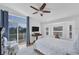Inviting bedroom with a ceiling fan, a balcony, and large windows offering serene outdoor views at 3 Pointe Way, Placida, FL 33946
