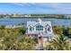 Stunning coastal home with a metal roof, multiple balconies, and scenic waterfront views at 3 Pointe Way, Placida, FL 33946