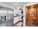 Modern laundry room equipped with a stainless steel refrigerator, washer/dryer, elevator and ample storage at 3 Pointe Way, Placida, FL 33946