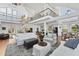Bright, open-concept living room with high ceilings, spiral staircase and views to the kitchen at 3 Pointe Way, Placida, FL 33946