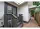 Charming back entry with gray painted steps leading to double doors, accented by clean white siding at 318 W Haya St, Tampa, FL 33603
