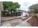 An ample backyard showcases a lovely screened-in porch and a paver patio for outdoor activities at 318 W Haya St, Tampa, FL 33603