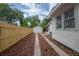 Backyard featuring a new wooden fence and a one car detached garage for additional storage at 318 W Haya St, Tampa, FL 33603