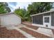 Spacious backyard includes a detached one-car garage, a screened porch and paver patio at 318 W Haya St, Tampa, FL 33603
