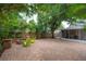 Expansive backyard with brick patio, fire pit, green chairs and screened in porch at 318 W Haya St, Tampa, FL 33603