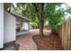 Spacious backyard with brick patio, mature trees, fire pit, and screened porch for outdoor living at 318 W Haya St, Tampa, FL 33603