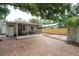 Spacious backyard featuring a brick patio and screened porch offering an inviting outdoor living space at 318 W Haya St, Tampa, FL 33603