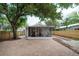 Expansive backyard with brick patio, mature trees, and a screened porch for outdoor living at 318 W Haya St, Tampa, FL 33603