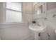 Well-lit bathroom boasts a pedestal sink, mirrored cabinet, and beadboard walls at 318 W Haya St, Tampa, FL 33603