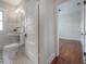 Traditional bathroom features a pedestal sink, hexagon tile floor, and an open doorway at 318 W Haya St, Tampa, FL 33603