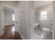 Hallway view to the renovated bathroom showcases classic features such as clawfoot tub and pedestal sink at 318 W Haya St, Tampa, FL 33603