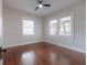 Bright, minimalist bedroom features wood floors, two windows, and a modern ceiling fan at 318 W Haya St, Tampa, FL 33603