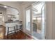 Dining area with bar seating, hardwood floors, and double doors that lead to the backyard at 318 W Haya St, Tampa, FL 33603