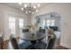 Charming dining area features modern lighting, dark wood table, and a view into the adjacent living room at 318 W Haya St, Tampa, FL 33603