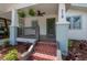 Close-up of a bungalow's welcoming front porch with a view of a green door at 318 W Haya St, Tampa, FL 33603