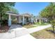 Comfortable single story home with a front porch and carport with driveway, offering convenience at 318 W Haya St, Tampa, FL 33603
