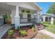 Welcoming front porch of a charming house with elegant plants and brick stairs at 318 W Haya St, Tampa, FL 33603