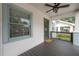 Side view of a cozy front porch with grey plank flooring and green trim at 318 W Haya St, Tampa, FL 33603