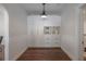 Bright hallway features a wall of built-in storage cabinets and drawers with decorative molding and hardwood floors at 318 W Haya St, Tampa, FL 33603