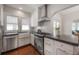 Well-lit kitchen showcases stainless steel appliances, white cabinets, and dark stone countertops at 318 W Haya St, Tampa, FL 33603