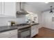 Bright kitchen features stainless steel appliances, an arched entry to dining area, and built-in storage at 318 W Haya St, Tampa, FL 33603