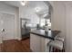 Modern kitchen featuring white cabinets, stainless steel appliances, and a breakfast bar with seating at 318 W Haya St, Tampa, FL 33603