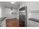 A kitchen with stainless steel appliances and white cabinets also includes hallway storage and dark countertop at 318 W Haya St, Tampa, FL 33603