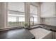 A white farmhouse sink is showcased under double windows with a pull-down faucet and dark countertops at 318 W Haya St, Tampa, FL 33603