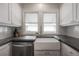 The kitchen features a white farmhouse sink and stainless steel faucet under double windows at 318 W Haya St, Tampa, FL 33603