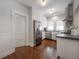 Bright kitchen with stainless steel appliances, farmhouse sink, and white cabinets with hardwood floors at 318 W Haya St, Tampa, FL 33603