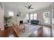 Inviting living room with a brick fireplace, hardwood floors, and a comfortable seating arrangement at 318 W Haya St, Tampa, FL 33603