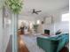 Bright living room featuring a fireplace, ceiling fan, hardwood floors, and a seamless transition into the dining area at 318 W Haya St, Tampa, FL 33603