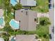 An aerial view of a home with a pool, lush greenery, and a well-manicured lawn at 338 7Th N Ave, Tierra Verde, FL 33715