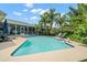 Inviting backyard with a pristine pool, lounge chairs, and lush tropical landscaping at 338 7Th N Ave, Tierra Verde, FL 33715