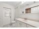 Bathroom featuring a white sink, mirror, toilet and door to the outside at 338 7Th N Ave, Tierra Verde, FL 33715