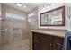 Bathroom showcasing a glass-enclosed shower, granite-topped vanity, and a large mirror with recessed lighting at 338 7Th N Ave, Tierra Verde, FL 33715