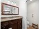 Bathroom features a granite-topped vanity, framed mirror, and a separate toilet room for added privacy at 338 7Th N Ave, Tierra Verde, FL 33715