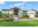 Charming single-story home with a welcoming entrance, beautiful landscaping, and a two-car garage at 338 7Th N Ave, Tierra Verde, FL 33715