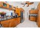 Well-equipped kitchen features dark granite counters, cabinetry, and tiled floor at 338 7Th N Ave, Tierra Verde, FL 33715