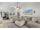 Open-concept living room with vaulted ceiling, cozy furniture, and lots of natural light at 338 7Th N Ave, Tierra Verde, FL 33715