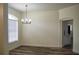 Open dining room with chandelier, hardwood floors, and large window for plenty of natural light at 3405 Silver Glen Ct, Plant City, FL 33566