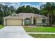 Charming single-story home with a two-car garage, mature landscaping, and a well-maintained lawn at 3405 Silver Glen Ct, Plant City, FL 33566